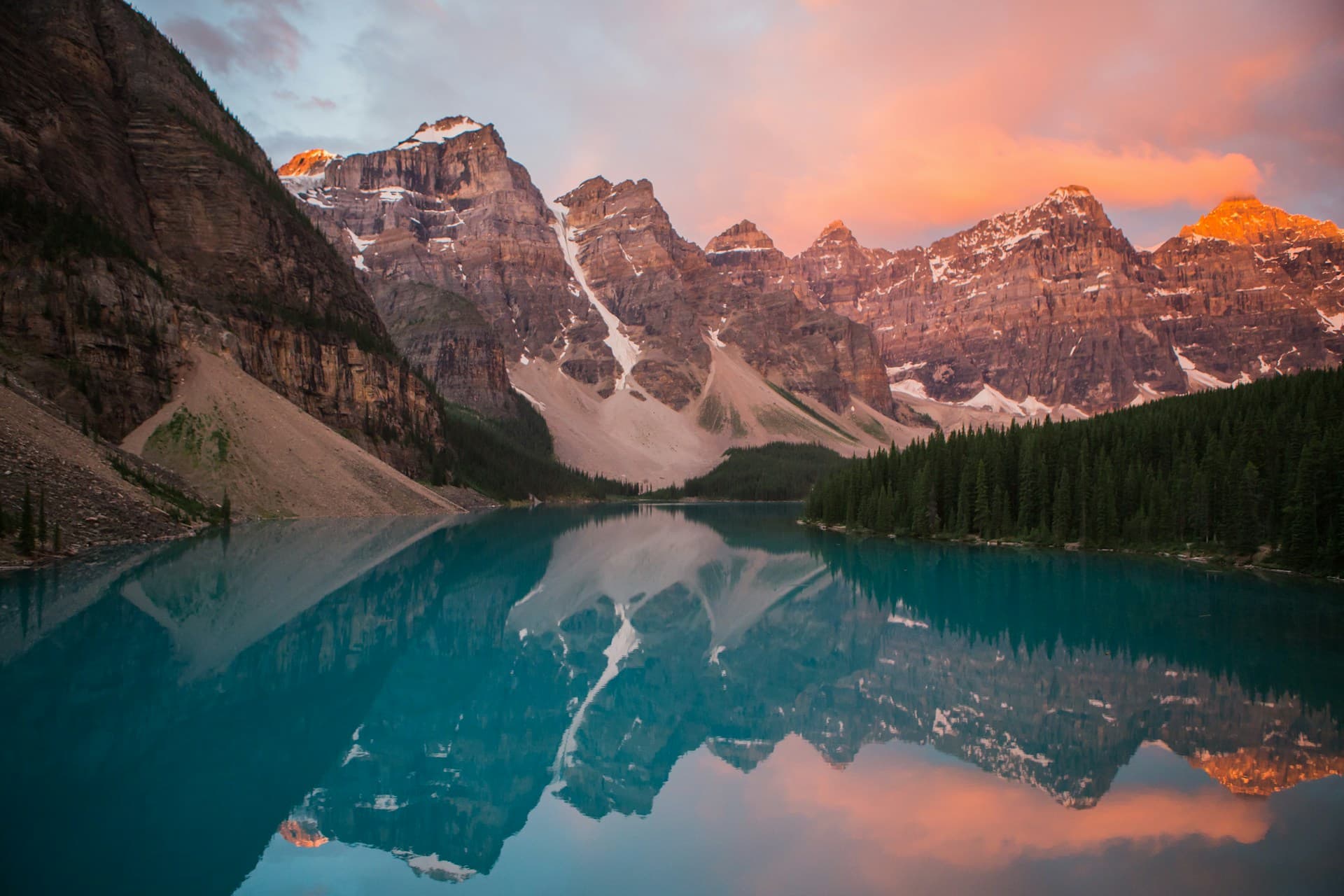 Dramatic mountain lake reflecting golden sunrise light